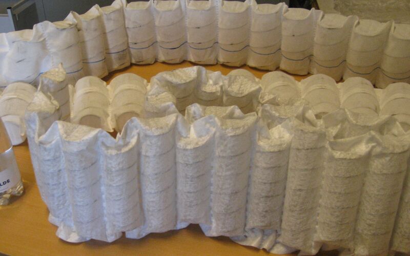 Bed springs being compacted in RUNI compactor