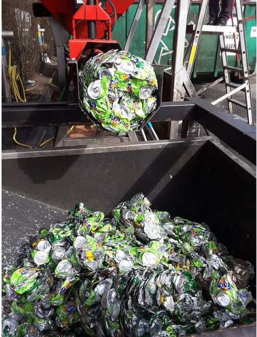 Aluminum cans being dewatered and compacted.  Aluminum cans being dewatered and compacted.